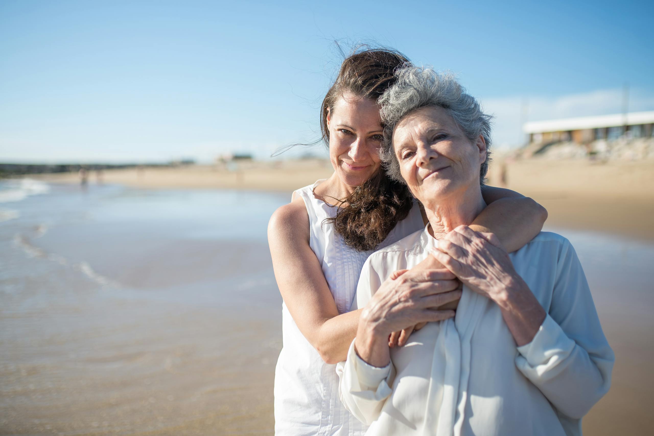 A woman embracing an elderly family member, representing support through the stages of Alzheimer's